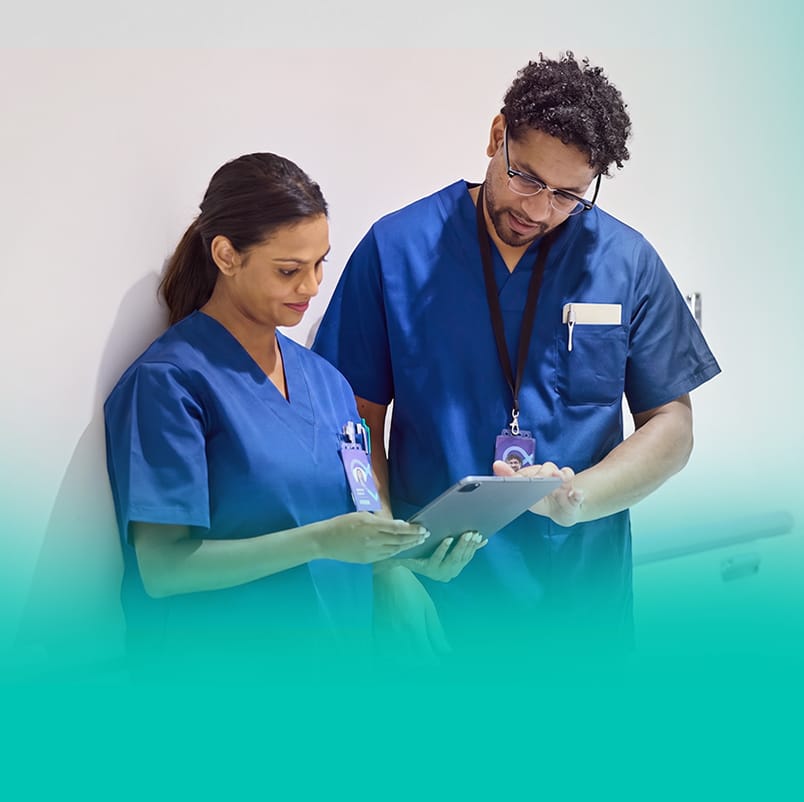 Two nurses reviewing information together on a tablet