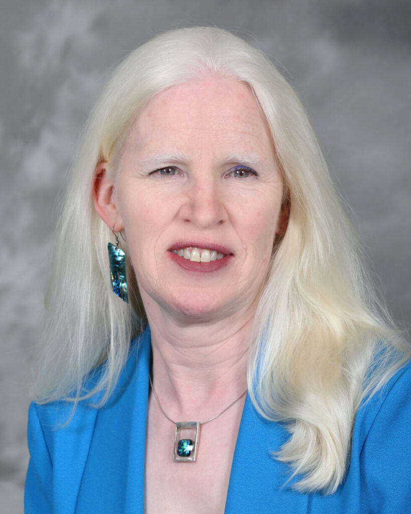 Professional headshot of a smiling female nurse leader
