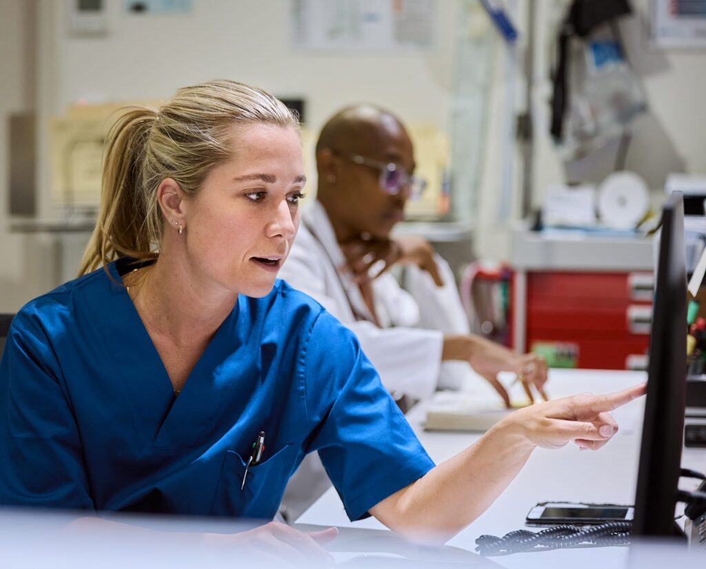 Nurse reviewing healthcare data on a computer