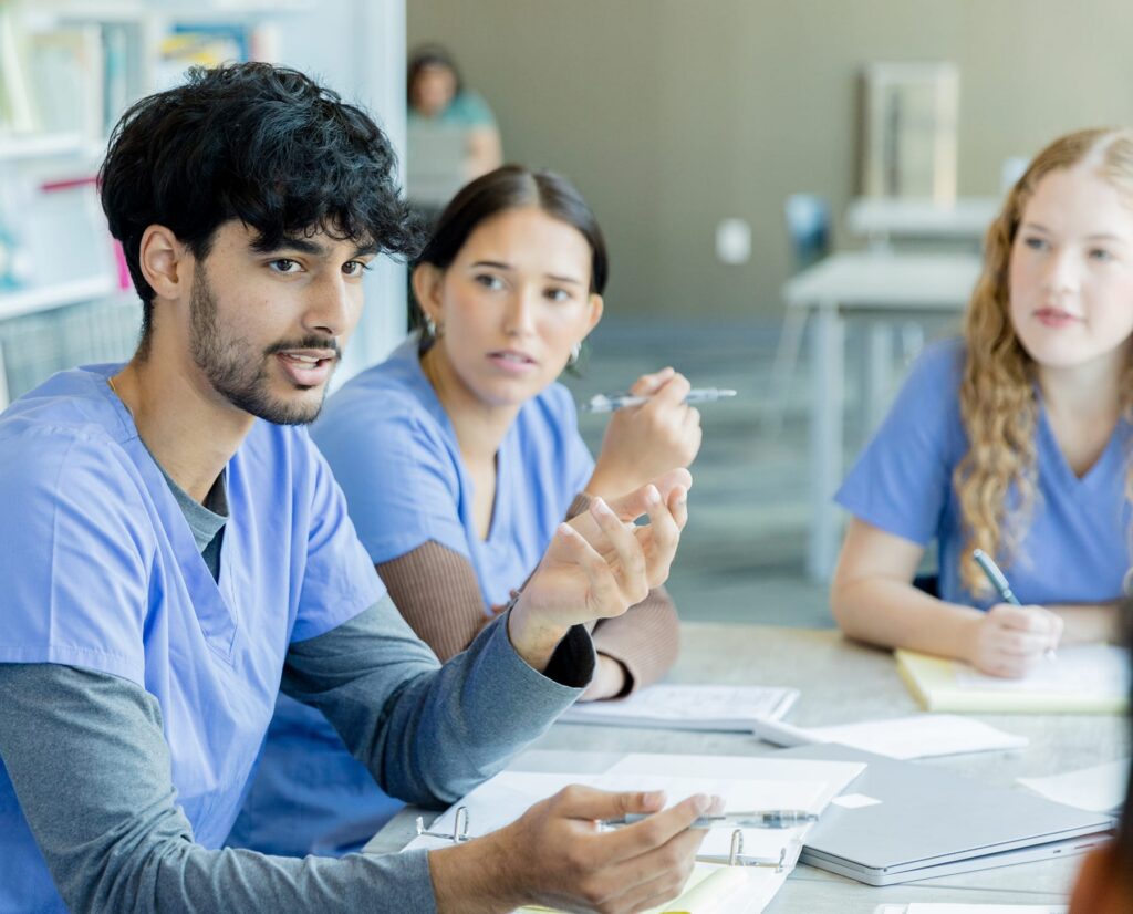 Nurse speaking during a meeting with healthcare colleagues
